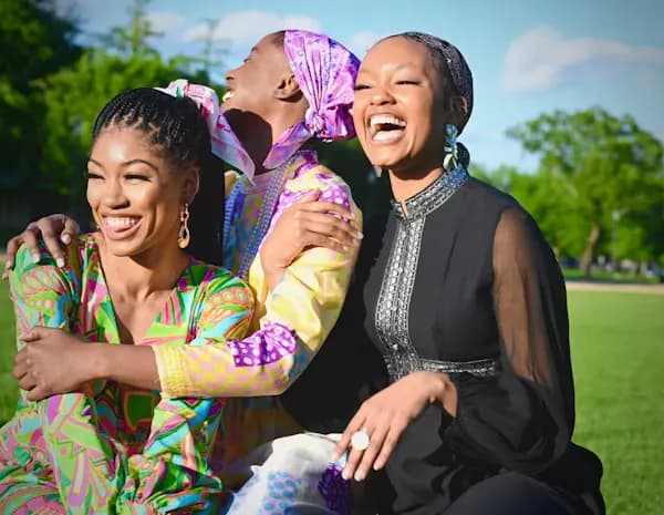  a group of healthy black women of various ages laughing and smiling